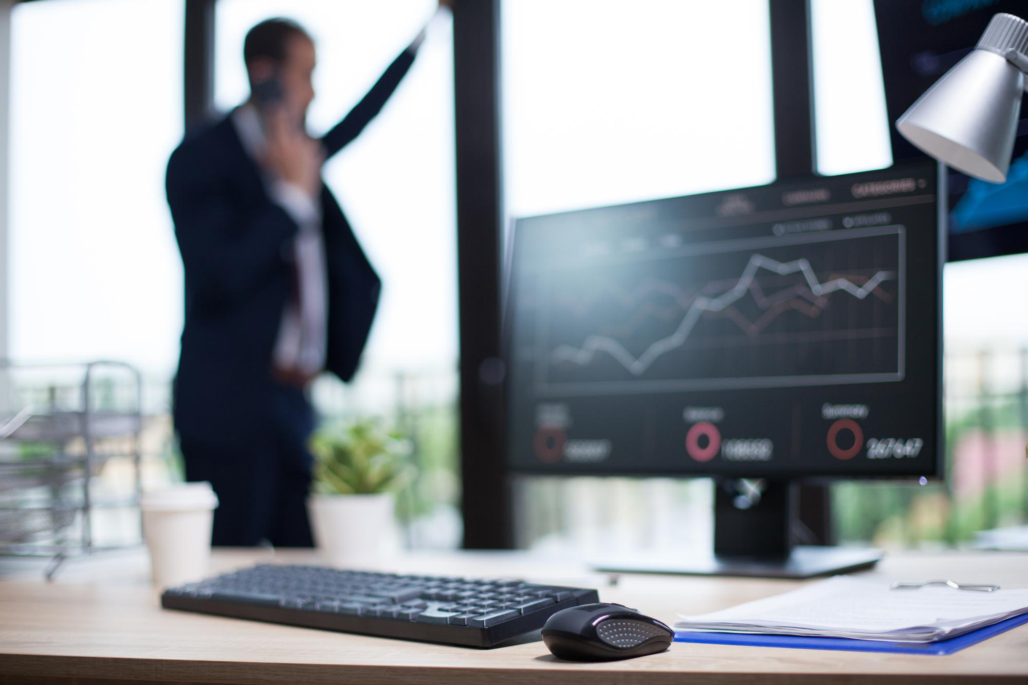 Workspace with financial charts on screen