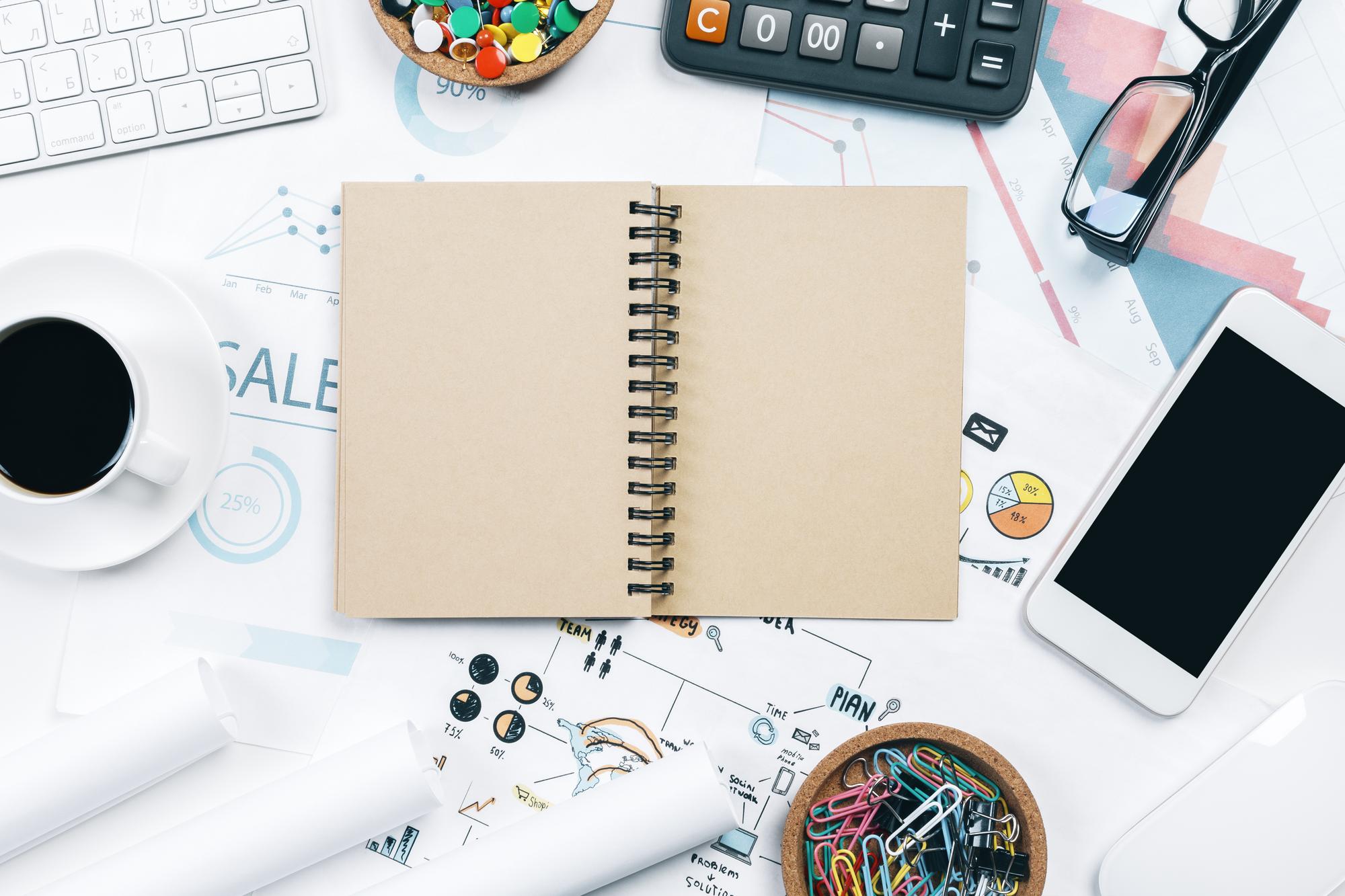 Open notebook with monthly plan and receipts